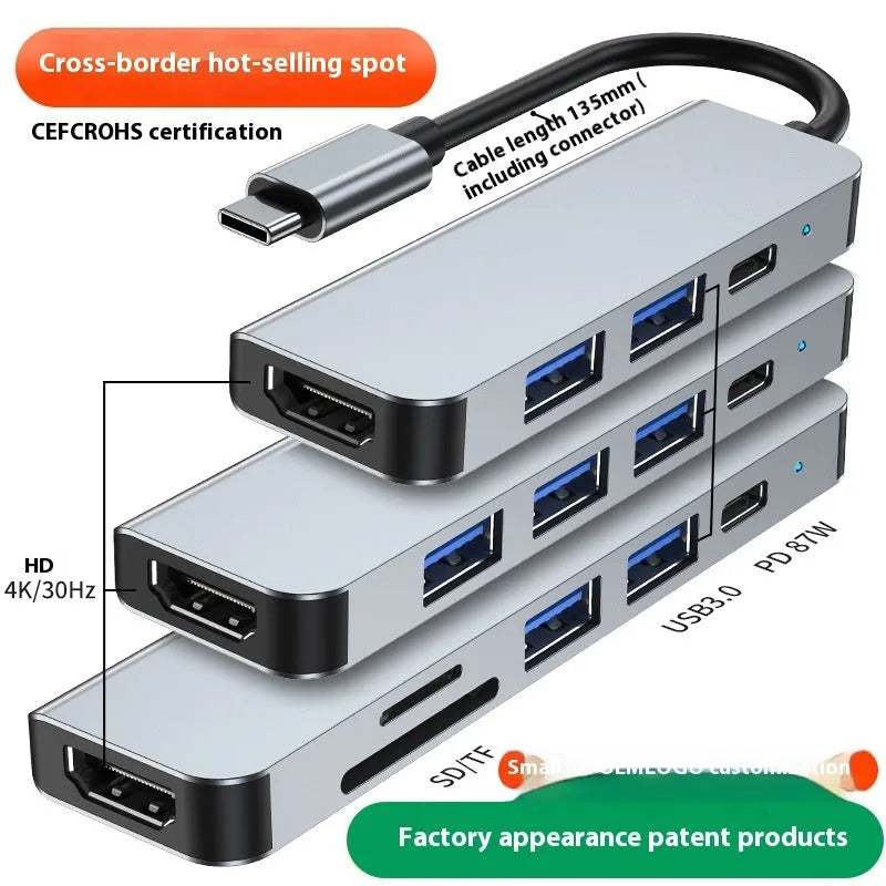 Silver aluminium USB-C expansion dock showing six ports including HDMI, USB 3.0, USB-C PD charging, and card readers