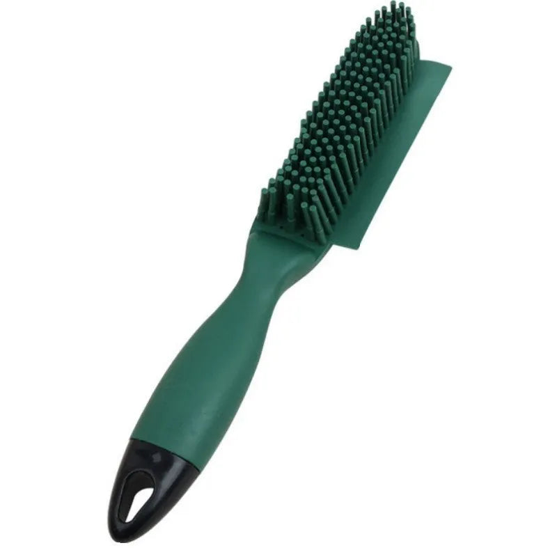 Green silicone pet hair remover brush with plastic handle on a fabric sofa