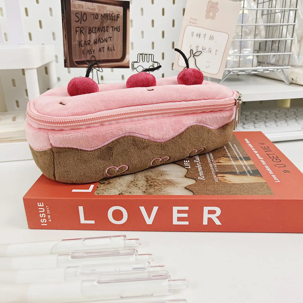 Cherry Cake plush velvet pencil bag with zip closure on a table.