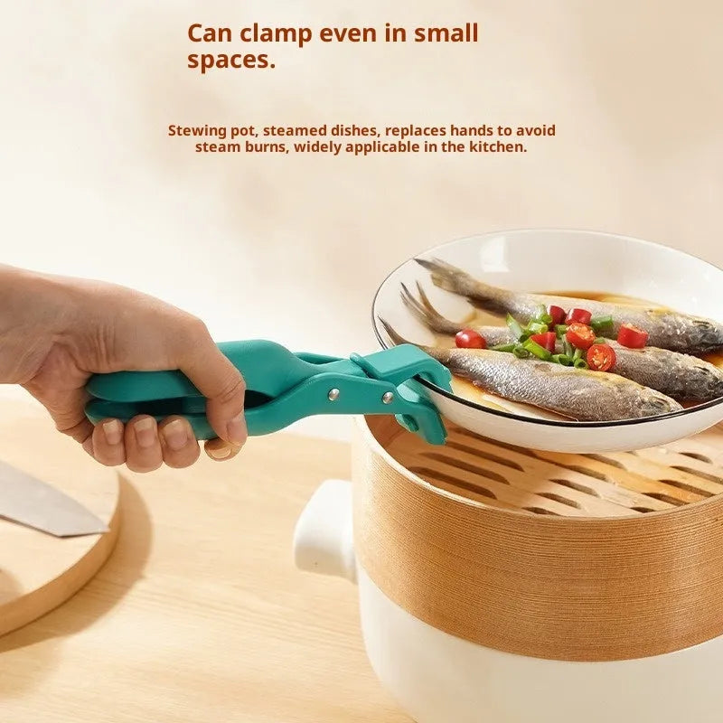Creative household kitchen silicone anti-scalding clip in carmine colour on a table with a nearby pot