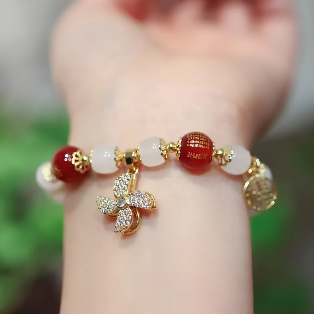 Chinese-style glass bracelet with coloured glaze, fu character, safety lock, windmill and bamboo presages charm designs