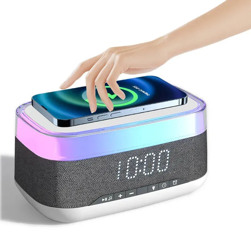 White multifunctional alarm clock with Bluetooth speaker, wireless charging pad, and night light.