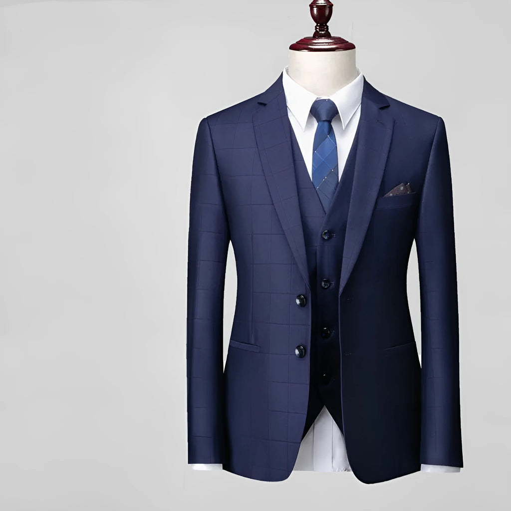 Men's navy blue three-piece plaid business casual suit with slim fit cut showing jacket, vest, and trousers