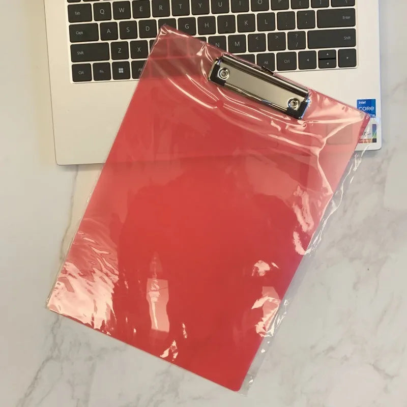 Transparent A4 writing board pad with metal clip holding paper, shown in blue colour option