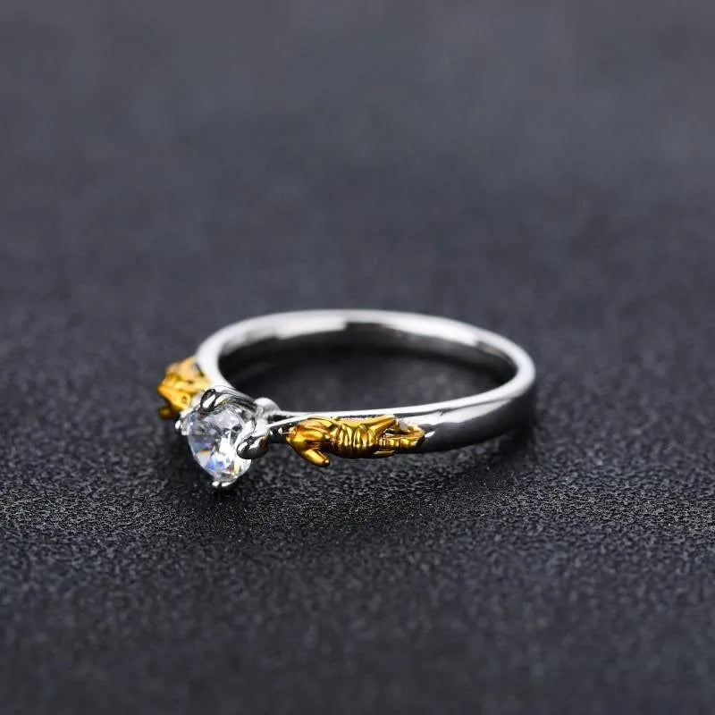 Close-up of a black gold plated crown ring on a finger, showing detailed copper modelling and a dark metallic finish.