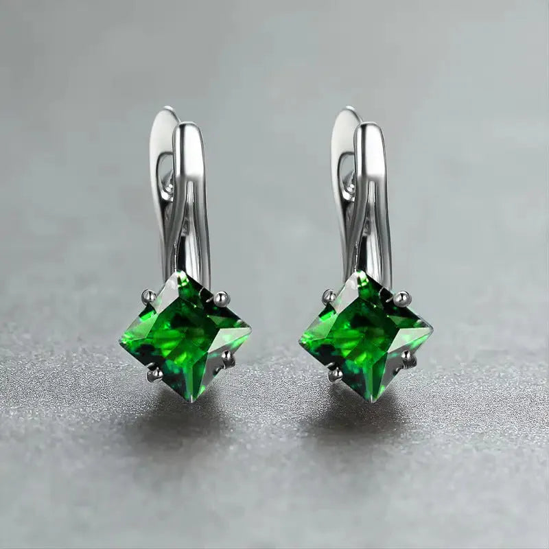 A pair of simple copper earrings with a diamond design created from inlaid zircon stones.