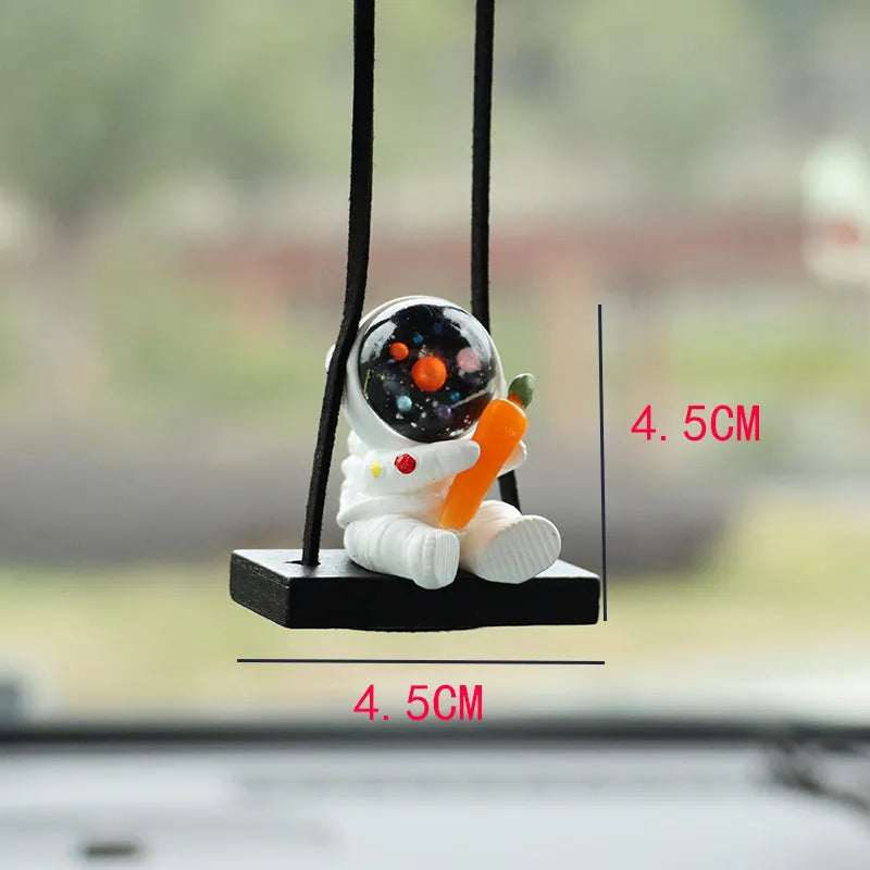 Cartoon style resin astronaut car pendant in five different colour and design variants.