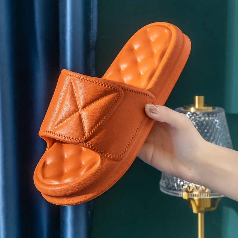 A pair of soft EVA bathroom slippers with a thick sole, shown in a choice of colours including black, caramel, green, pink, and yellow.