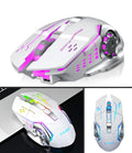 Black and white silent wireless computer mouse on a desk next to a laptop.