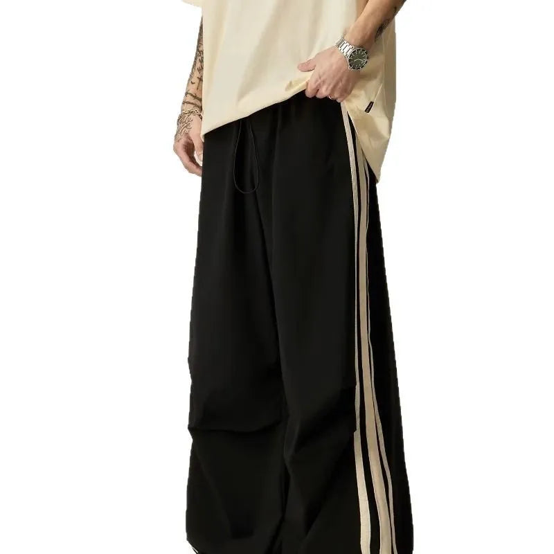 Black men's high-waisted wide-leg casual trousers laid flat.