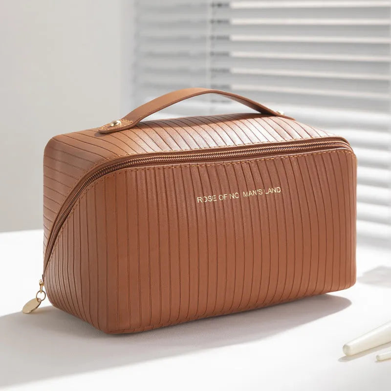 Vertical pattern pillow-shaped cubic makeup bag in PU material for women's travel storage.