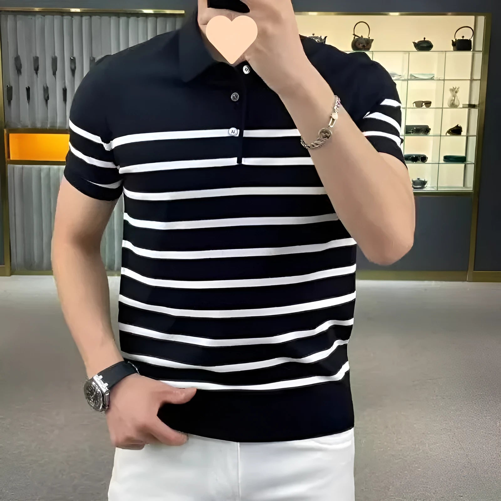 Black and white striped knitted pullover t-shirt with a lapel collar, laid flat.