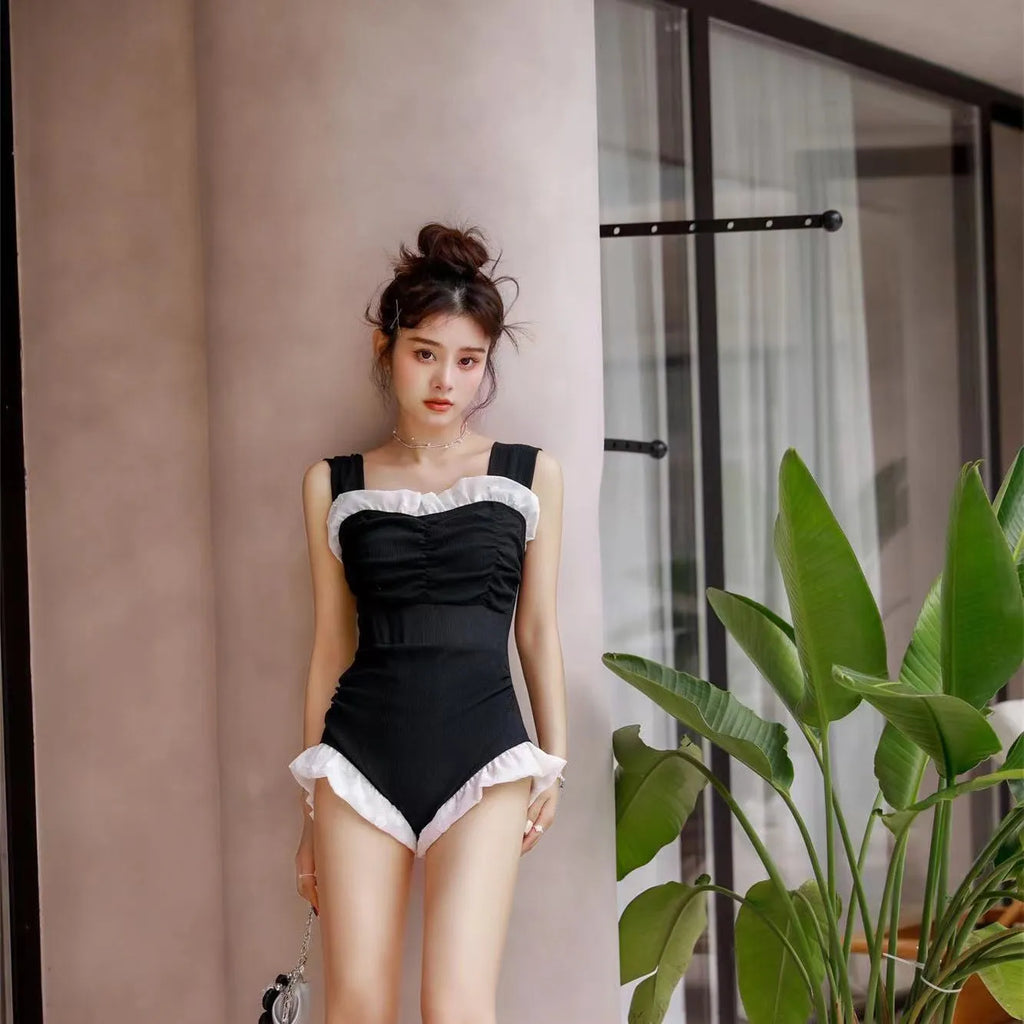 Korean-style high-waist one-piece swimsuit in black, pink, or green on a model