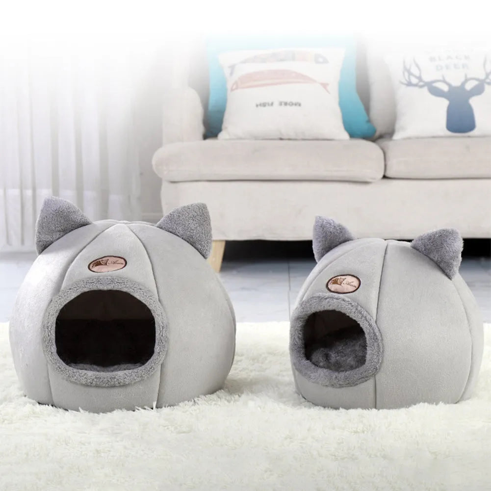 Grey enclosed cat sofa bed with a round entrance hole, showing a soft plush interior and removable cushion.