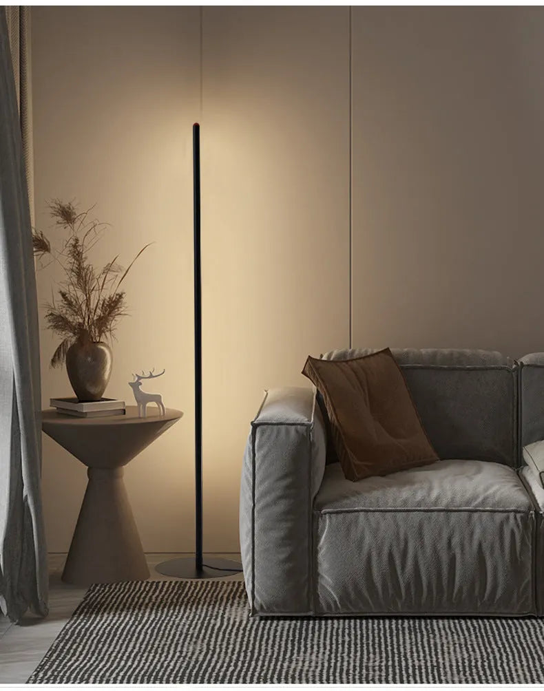 Vertical aluminium alloy floor lamp in modern simplicity style on a table.