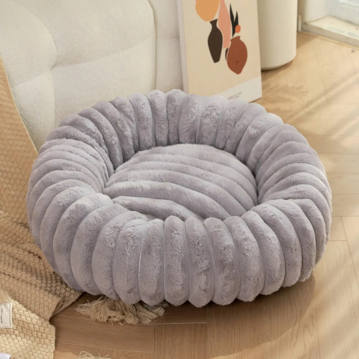 Round plush pet bed with long-hair rabbit fur style texture in beige colour