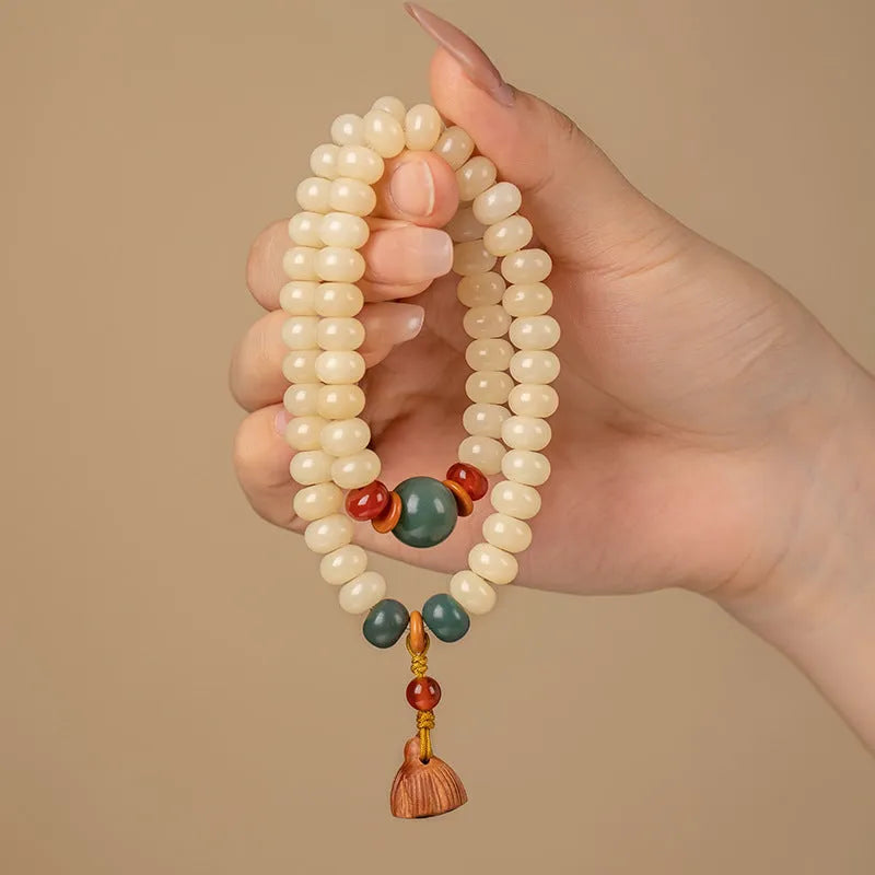 Cream topaz bodhi root wooden bracelet with flat round beads on wrist