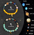 Set of twelve natural stone beaded bracelets laid out, each with different patterns for the zodiac signs.