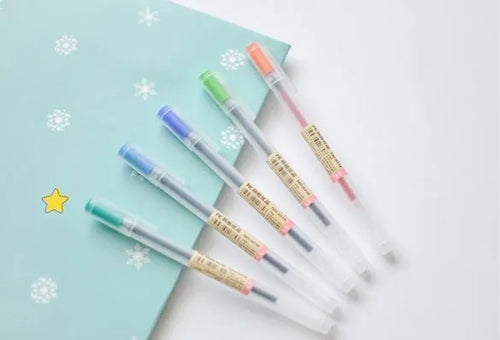 Pack of twelve black Muji gel pens with 0.5mm fine nibs, showing sleek barrel design