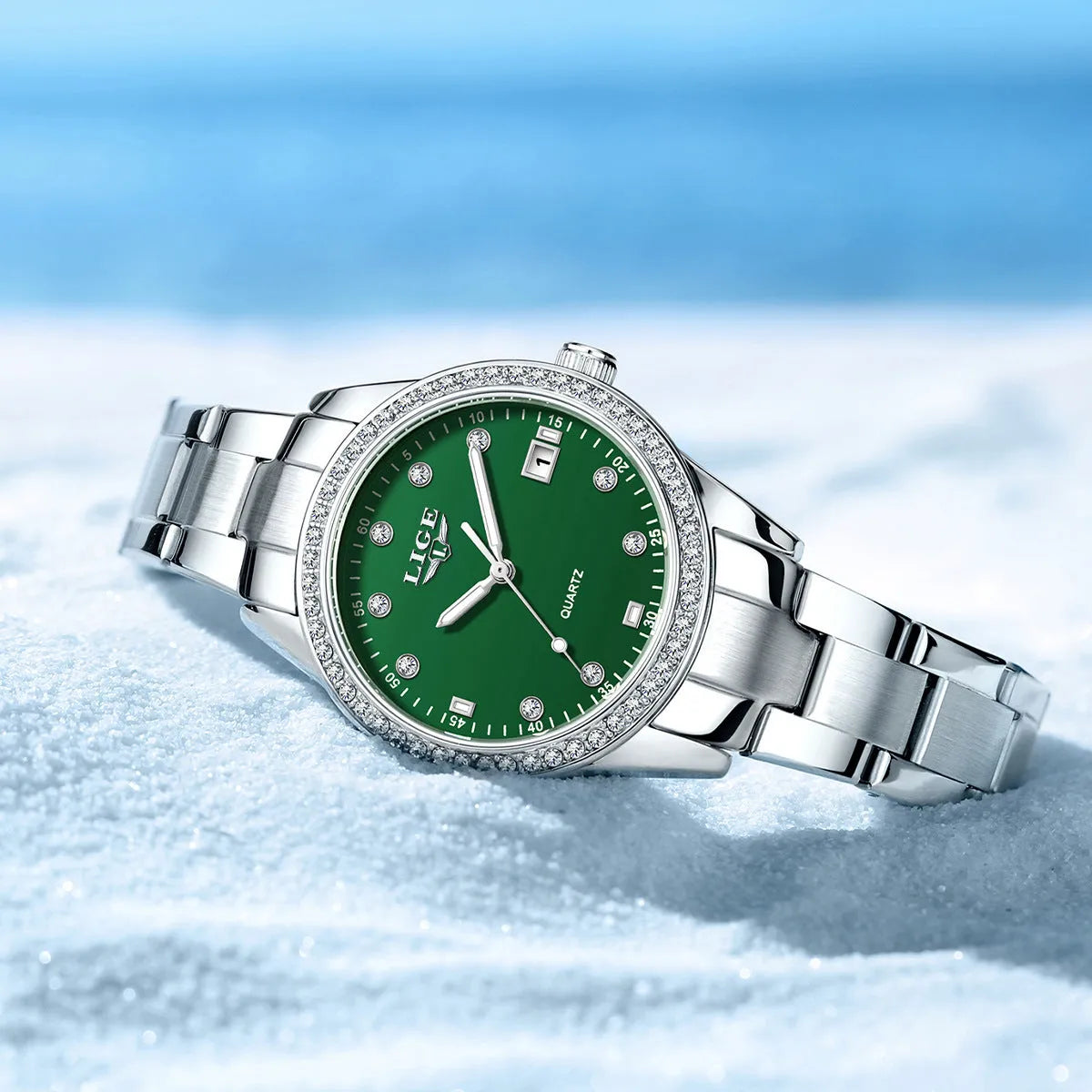 Silver fashion quartz watch with diamond bezel, round white dial, and luminous hands on a stainless steel strap.