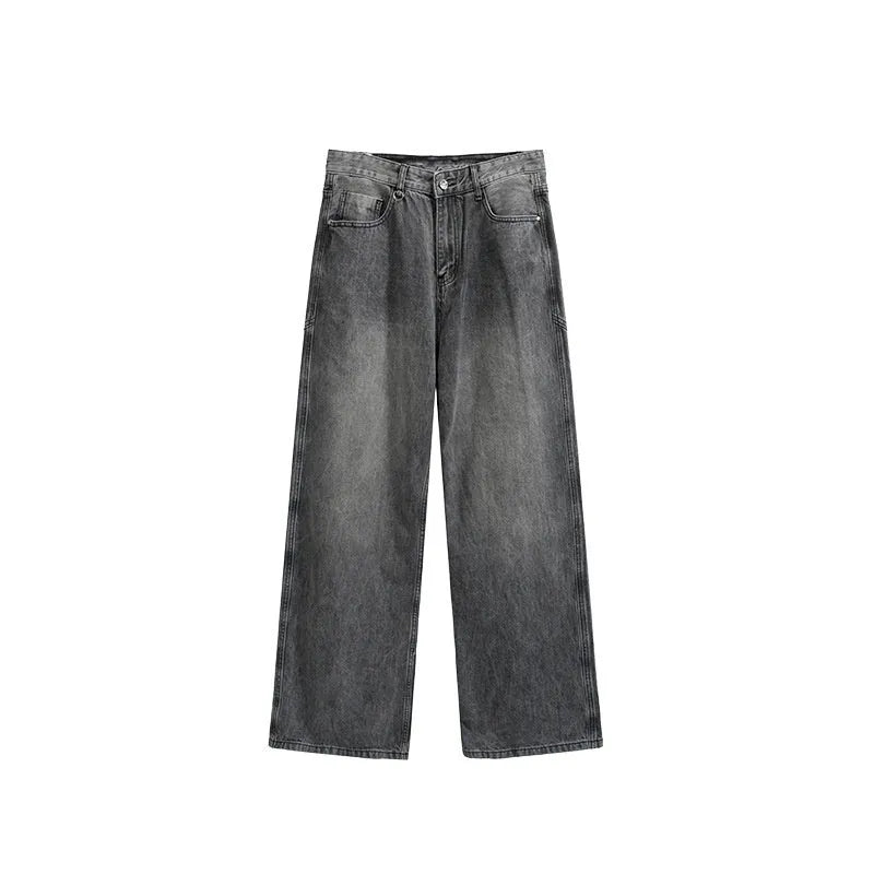 Man wearing washed blue wide leg straight-cut jeans with a mid waist and zipper fly.
