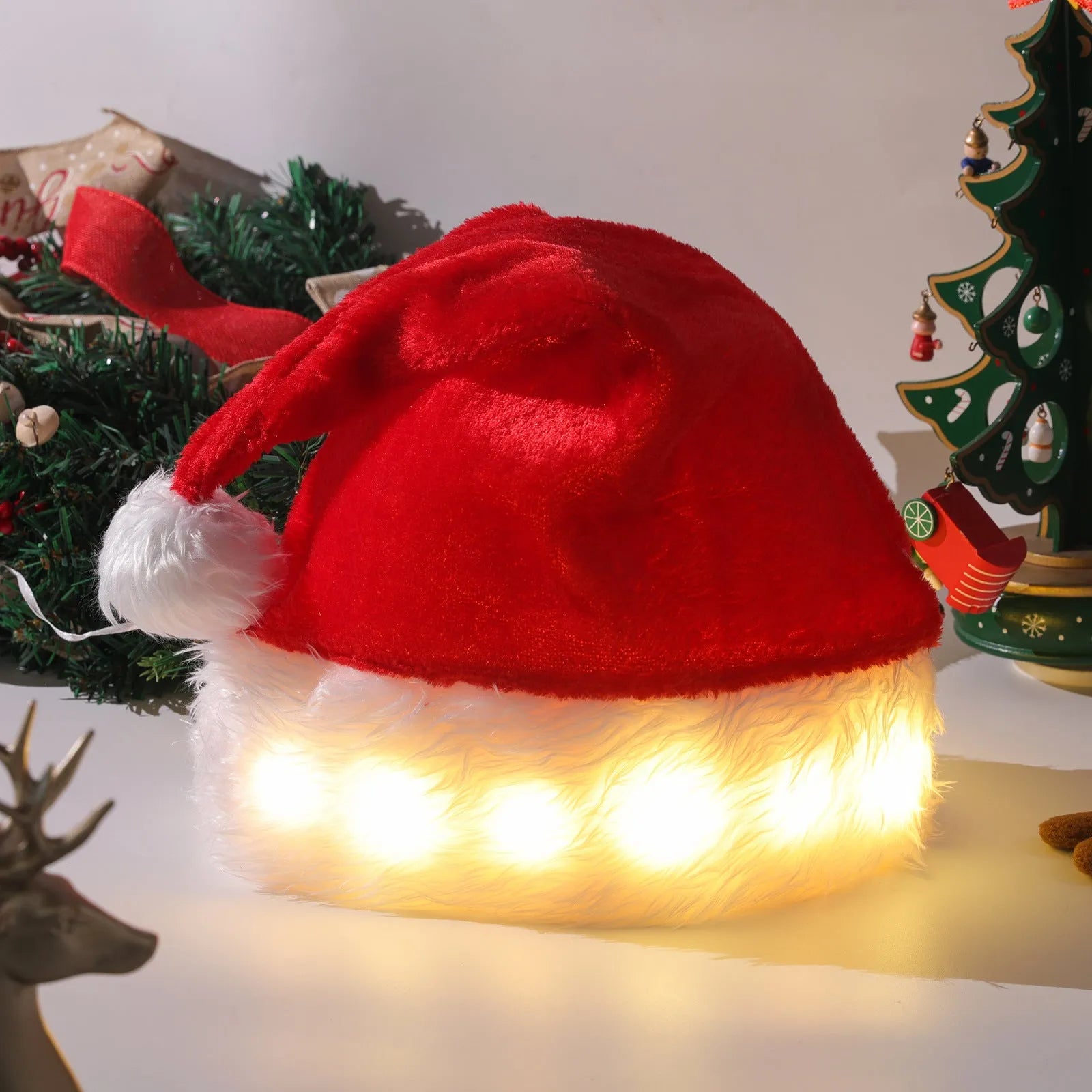 Red and white plush LED Santa hat with 20 colour-changing lights illuminated in festive display