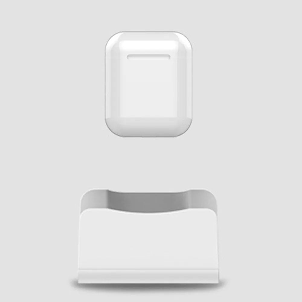 White minimalist headphone charging base on a desk or table