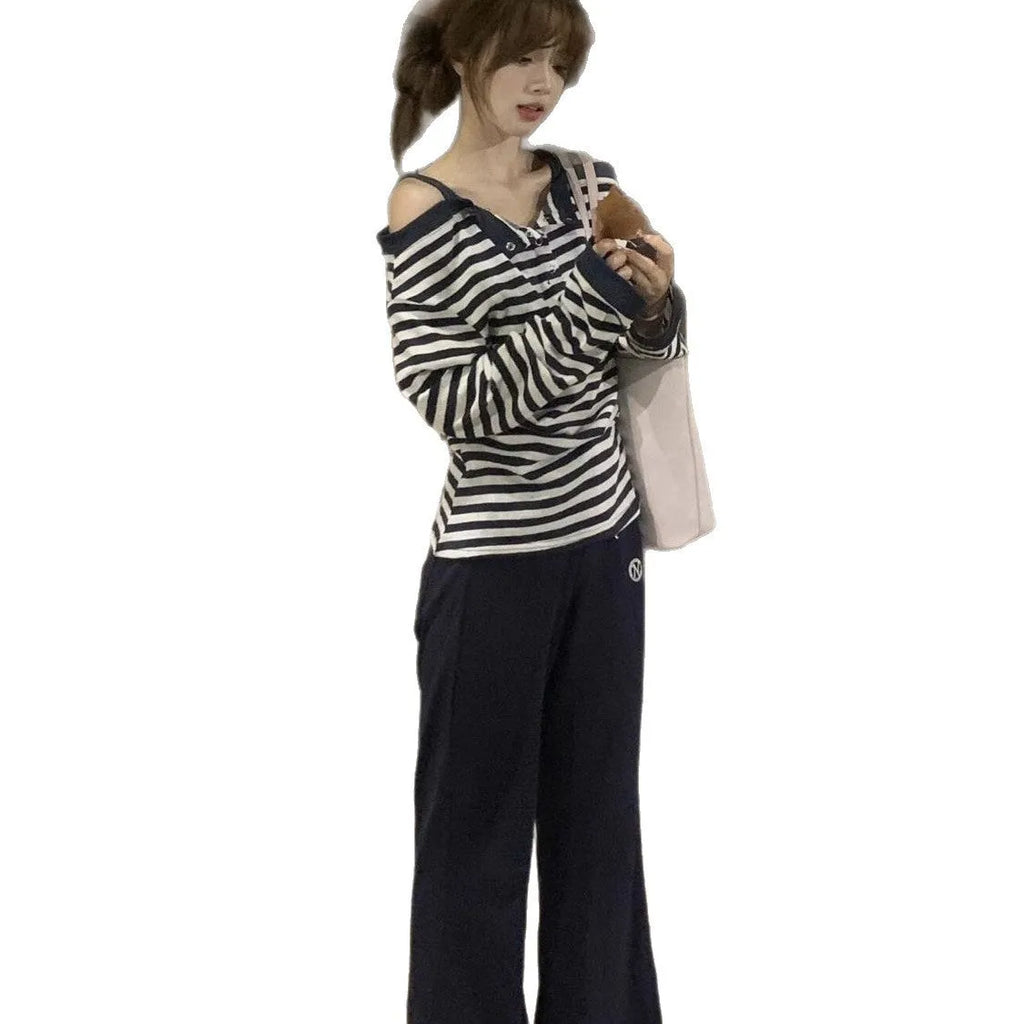 Dark blue women's oversized long-sleeve T-shirt with embroidered stripes and button details.