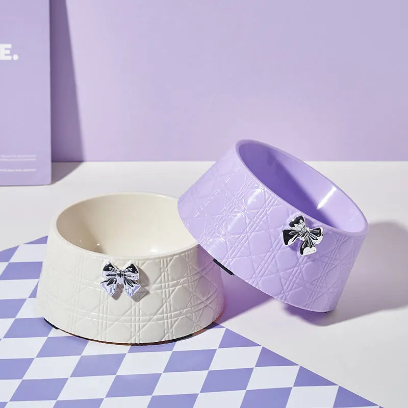 Diamond pattern pet feeding bowl with a bowknot decoration in black, purple or white with a pink or silver bow.