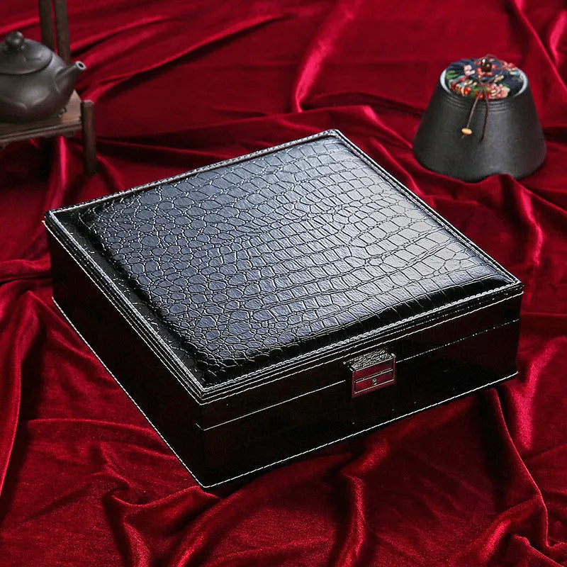 Green wooden double layer jewelry storage box with lock and crocodile pattern texture.