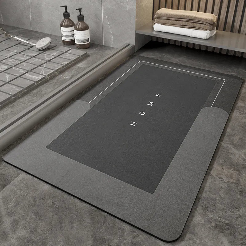 Machine-woven rectangular blue floor mat placed on a bathroom floor.