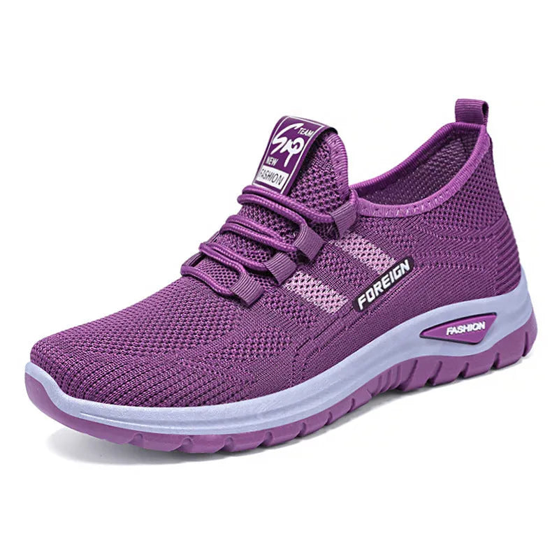 Low-top casual shoes with breathable mesh upper and flat PVC sole in black, grey, purple, or red.
