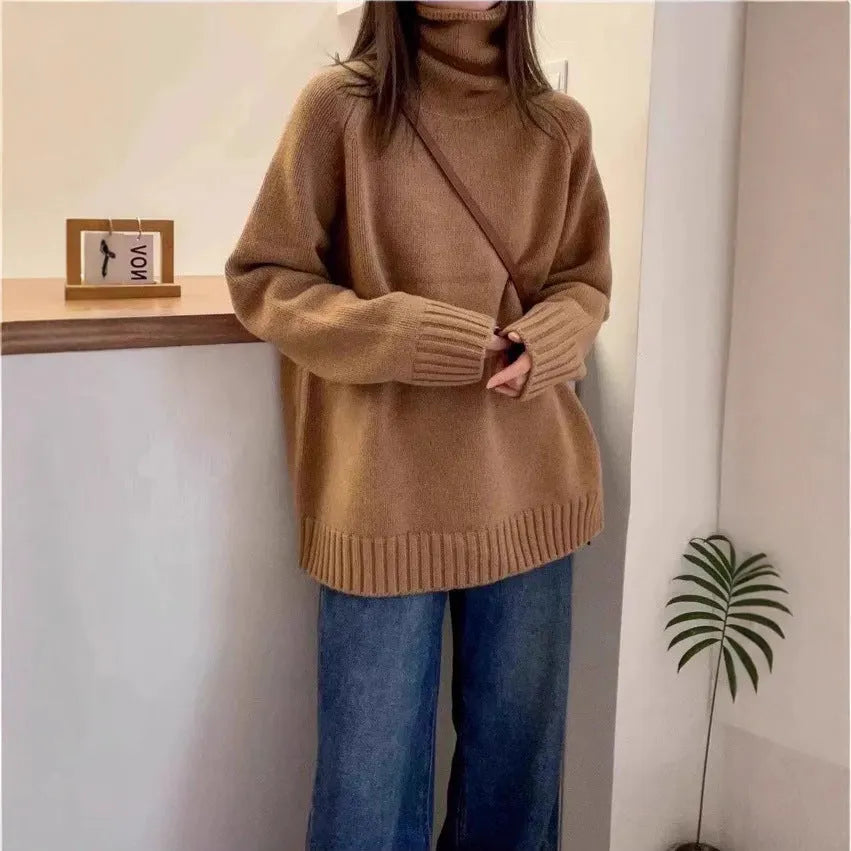 Women's loose fit grey turtleneck sweater with a thick curling pile collar on a hanger.