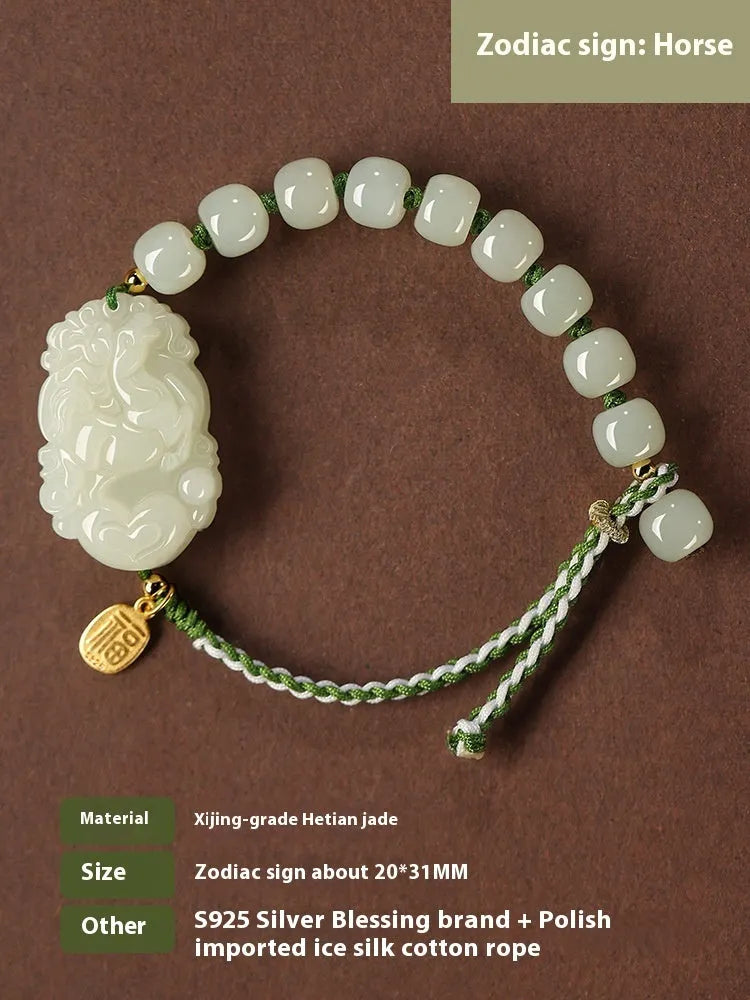 Close-up of a Rabbit zodiac charm Hetian jade bracelet with red rope and S925 silver card.