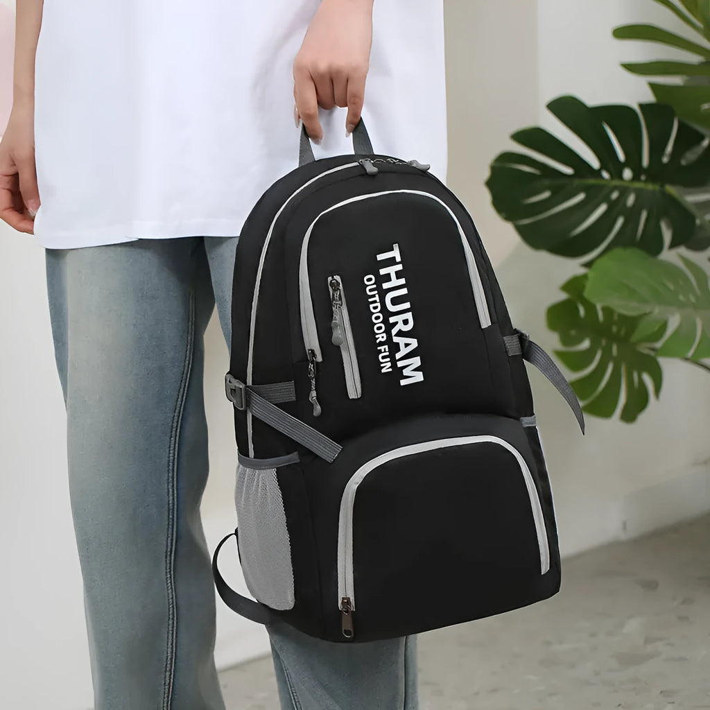 Dark blue folding outdoor backpack with straps, showing its large capacity and air pillow belt.