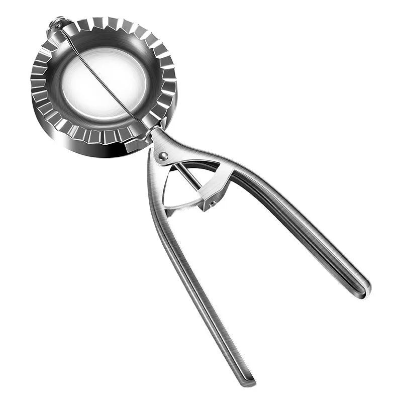 Silver-colour stainless steel manual dumpling mould on a kitchen counter.