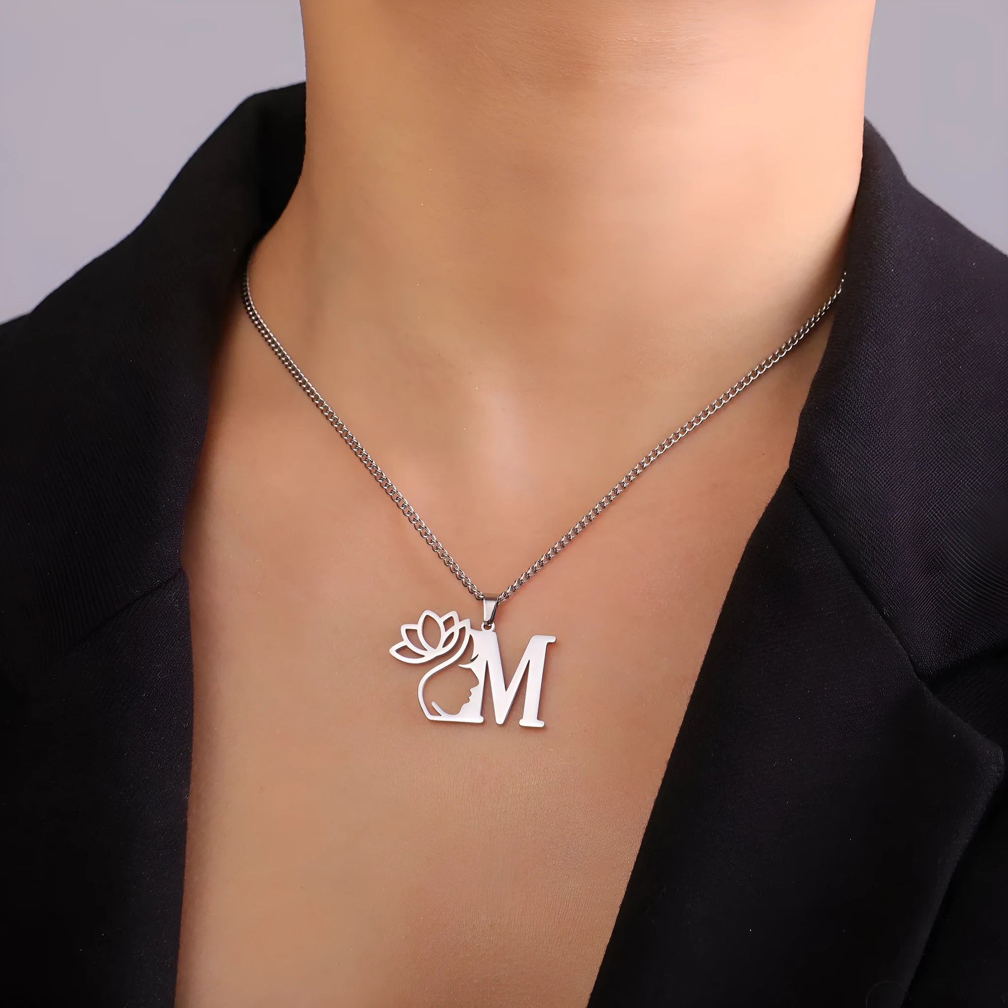 Stainless steel personalised letter necklace with gold finish on a 5mm wide cross chain, showing separate initial pendant.