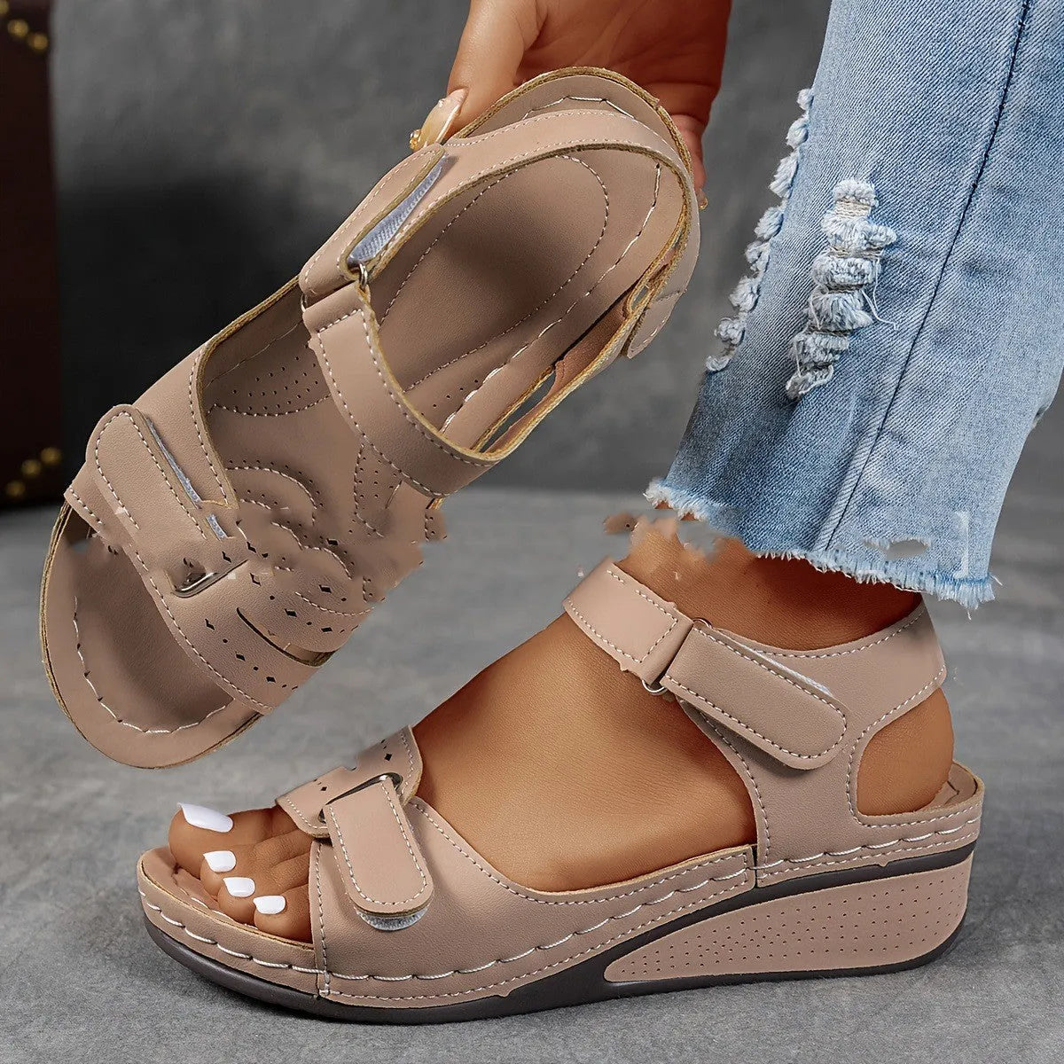 Women's beige thick-soled sandals with adjustable black Velcro straps on a white background.