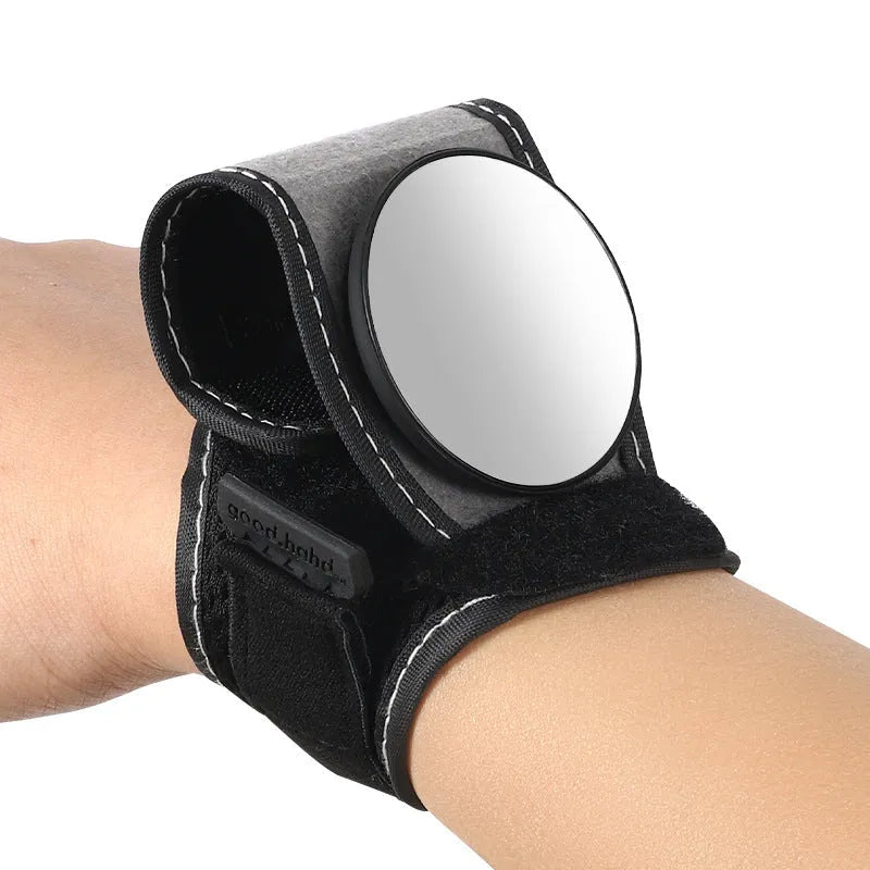 Black nylon bicycle rear-view mirror shown mounted on a cyclist's wrist.
