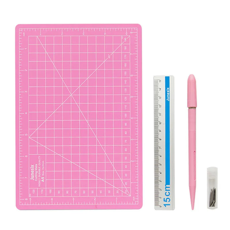 Art pen knife cutting board set showing plastic mat, metal ruler, sharpener and blade in assorted colours.