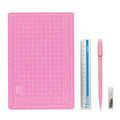 Art pen knife cutting board set showing plastic mat, metal ruler, sharpener and blade in assorted colours.