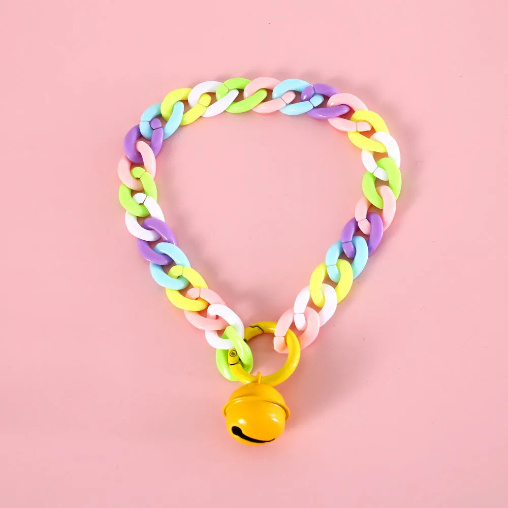 Soft plastic pet collar in pastel macaron candy colours with a chain-link design, shown in S and M sizes.