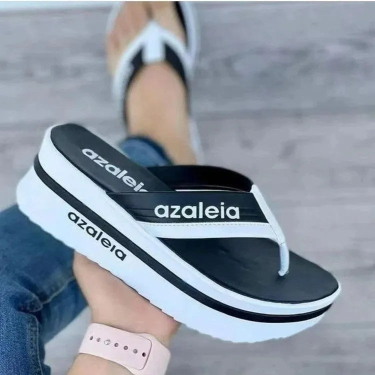 Women's solid colour PU platform slippers with a herringbone toe holder design.