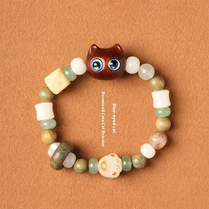 Hand-woven adjustable bracelet with bodhi seeds, jade beads, and a cartoon cat's paw guajacwood charm