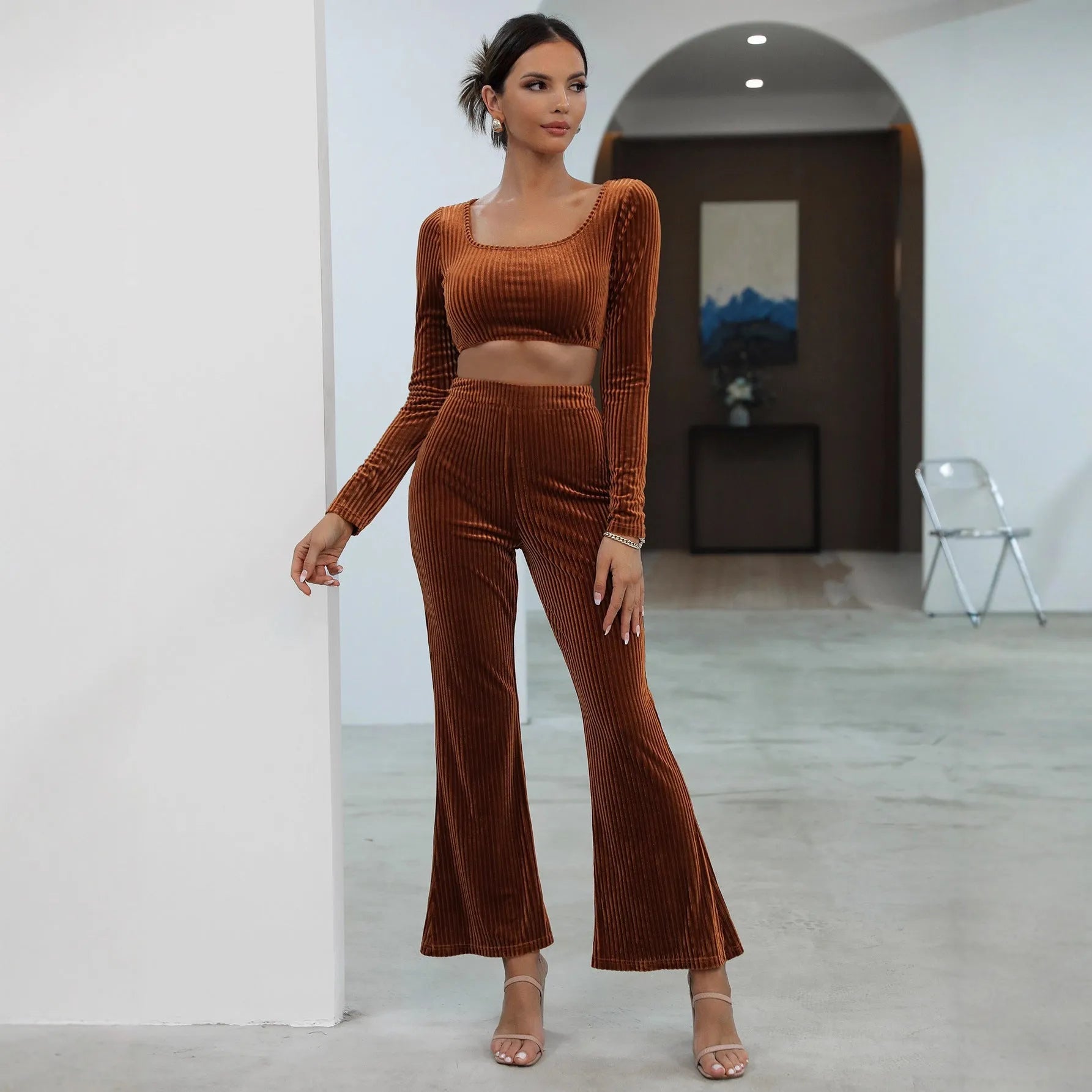 Caramel coloured long sleeve sweater and trouser set laid flat, showing casual two-piece design.