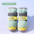 Pair of light blue breathable dog shoes with a cartoon style on a wooden floor.