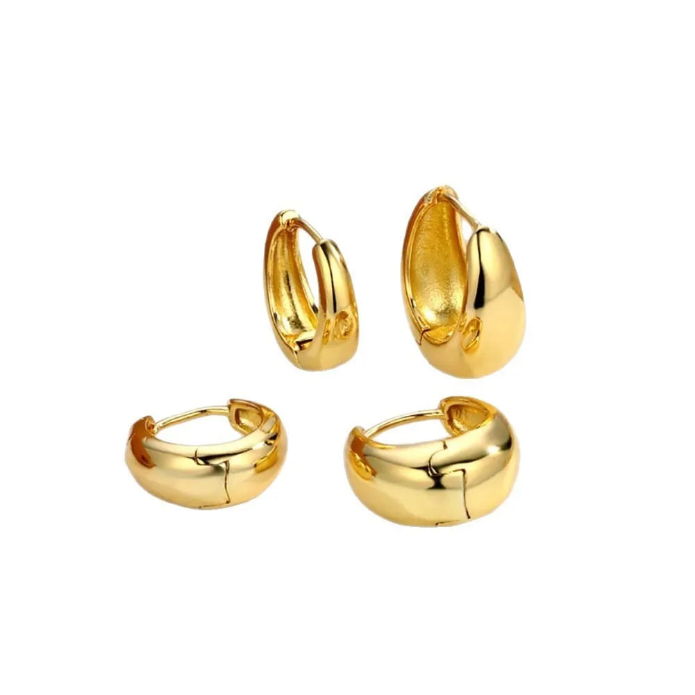 Three pairs of gold electroplated copper earrings with geometric ring design on a white background