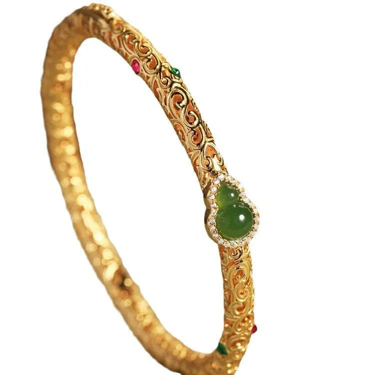 Gold-toned open design gourd charm bracelet with a dark adjustable silk cord for women.
