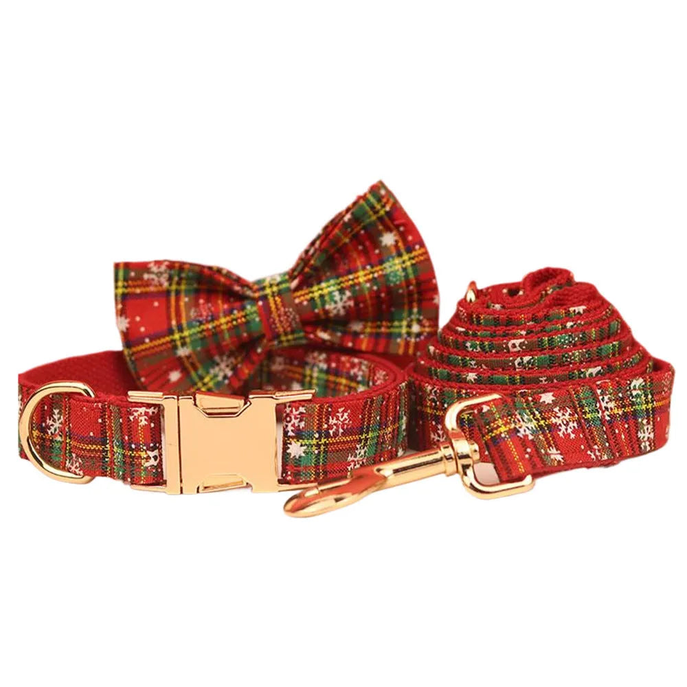 Four-piece Christmas pet accessory set with red snowflake collar, plaid leash, festive vest, and bow tie