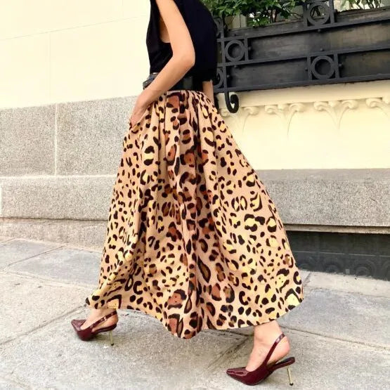 Brown leopard print women's A-line long skirt with a wide flowing hem on a model.